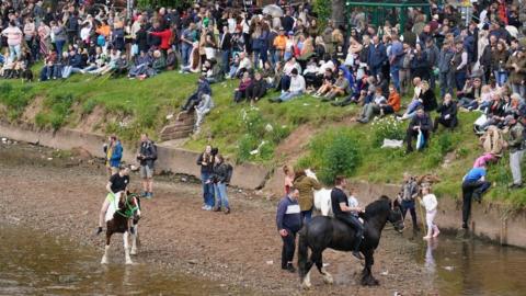 People watching horses at the Appleby Horse Fair