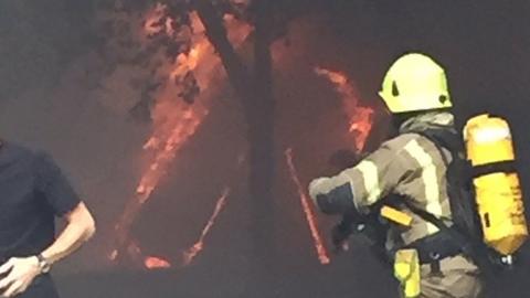 Firefighters attend the fire