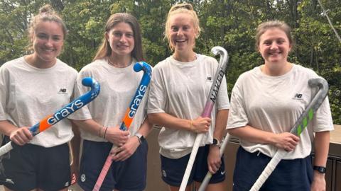 Scotland players with their hockey sticks