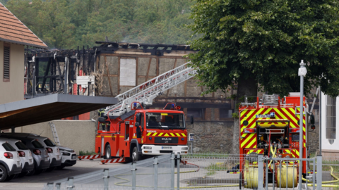 Firefighters work after a fire broke out at a holiday home for disabled people in Wintzenheim, France