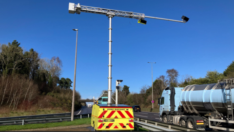 Mobile phone detecting camera using AI technology beside a road