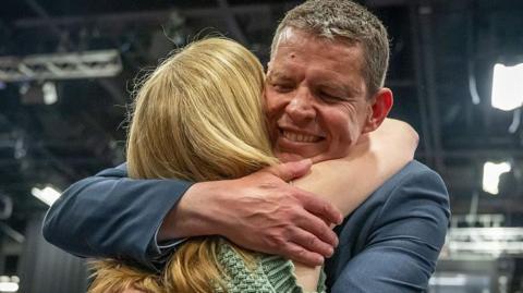 Plaid Cymru, Rhun ap Iorwerth hugs his wife Llinos at Venue Cymru on May 8, 2026 in Llandudno, Wales. 