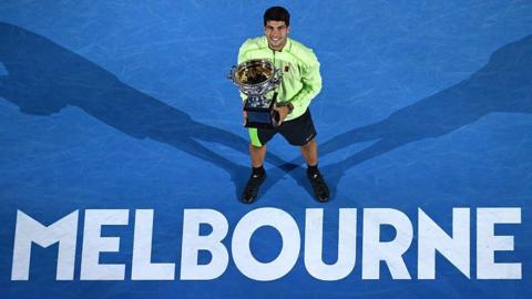 Carlos Alcaraz with the Australian Open trophy