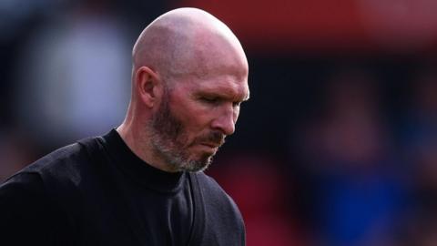 Michael Appleton looks towards the floor during a match
