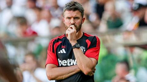 Michael Carrick looks on