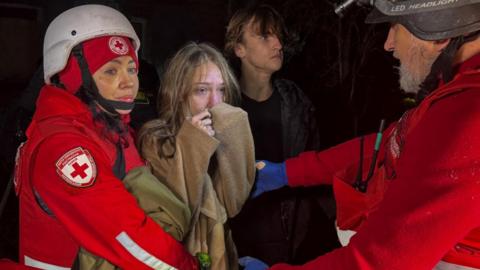 A girl reacts as her mother was killed during a Russia drone strike, amid Russia's attack on Ukraine, in Kharkiv, Ukraine November 23, 2025.