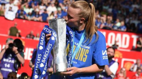 Chelsea striker Aggie Beever-Jones holding the WSL trophy