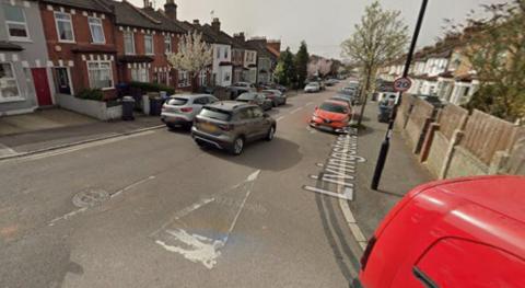 Residential street in Thornton Heath lined with terraced houses and parked cars, viewed from Livingstone Road.