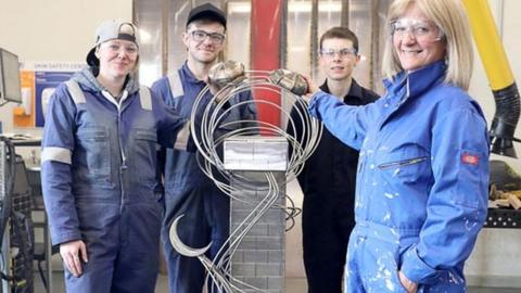 Catriona Tinsley and her sculpture, Puffin Bridge, with some of the Fabrication and Welding students