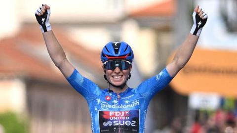 Demi Vollering celebrates at the finish line after clinching the overall victory in the women's Giro d'Italia of 2026