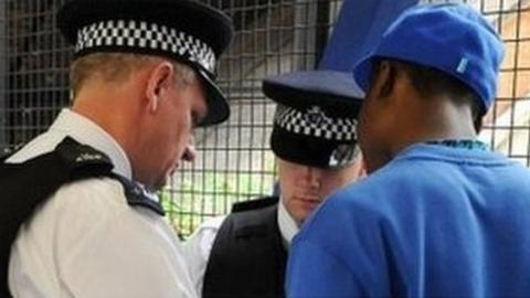 Police officers conduct a stop and search