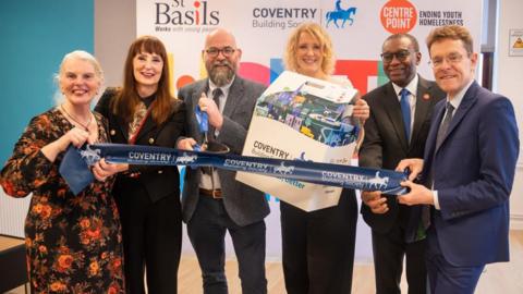 Six people cutting a Coventry Building Society ribbon