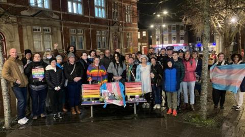 The group gathered at the Rainbow bench in Swindon for the vigil