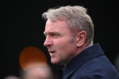 Carlisle manager Paul Simpson standing on the touchline during a game 