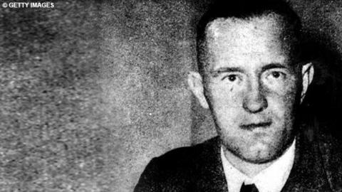 A black and white photograph of William Joyce, also known as Lord Haw Haw.