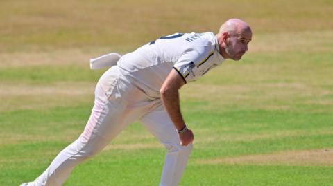 Chris Rushworth in action bowling.