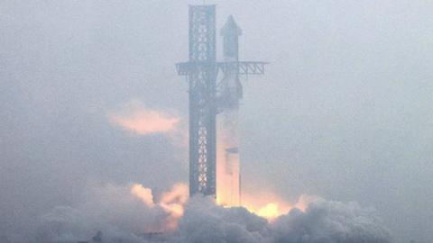 An image showing the Starship rocket as its engines fire up and it begins to take off