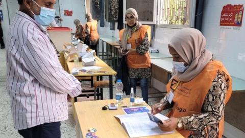 A Libyan man registers to vote inside a polling station in Tripoli, on November 8, 2021