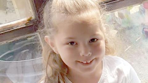 Olivia Pratt-Korbel, nine, with blonde hair tied in a pony tail, smiles for the camera. She is pictured wearing a white t-shirt.