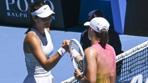 Emma Raducanu shakes hands with Iga Swiatek after their Australian Open match in January