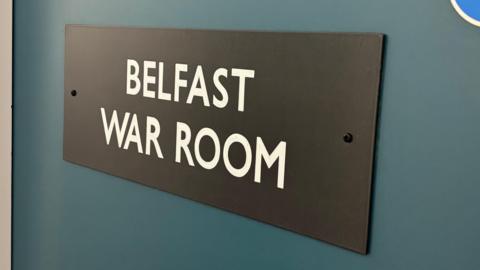 Sign on a door saying Belfast war room 