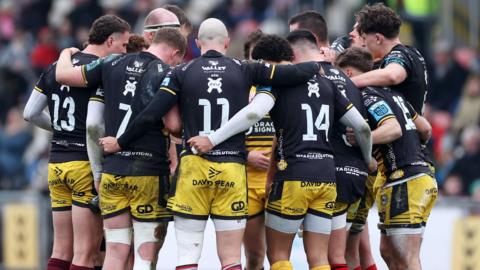 Dragons players in a huddle