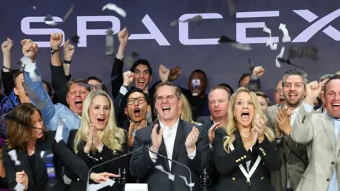 people cheer at the nasdaq open as spacex debuts.