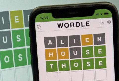 This images shows the screen of an IPhone, showing the screen of the online game, Wordle.