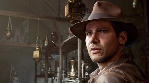 A photo of Indiana Jones taken from a video game with the character wearing a brown hat staring into the distance 