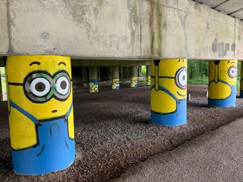 Motorway stanchions painted to look like a Minion - the yellow cartoon creations featured in the Despicable Me movies.