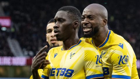 Ismaila Sarr celebrates a goal with Jean-Philippe Mateta