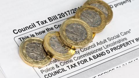 Council tax bill and pound coins
