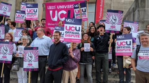 People striking outside a university