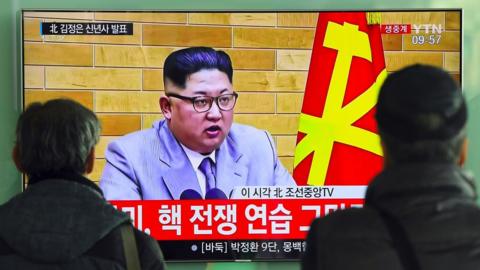 People watch a television news broadcast showing North Korean leader Kim Jong-Un"s New Year"s speech, at a railway station in Seoul on January 1, 2018.