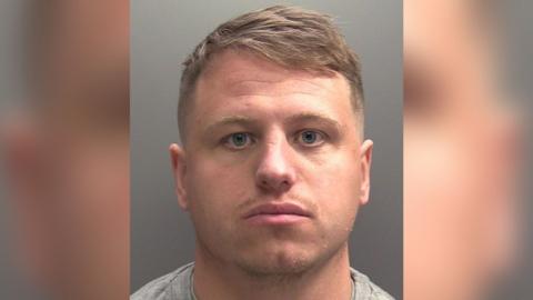 Police-issue custody photograph of Alex Holdsworth