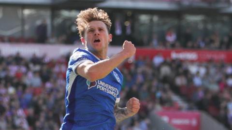 Adrian Segecic celebrates scoring a goal for Portsmouth