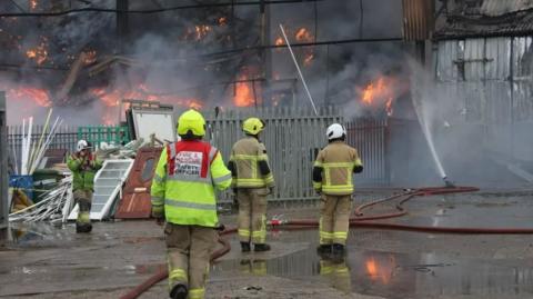 Fire crews tackling a fire at an industrial site