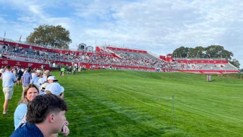 The stand that bends around the back of the first tee and 18th green at Bethpage Black