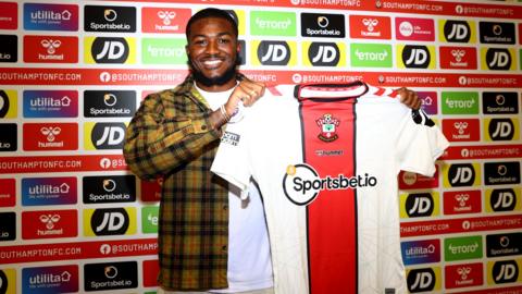 Ainsley Maitland-Niles holds a Southampton shirt after joining on loan