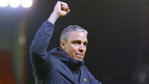 Wycombe boss Michael Duff raises a fist in celebration
