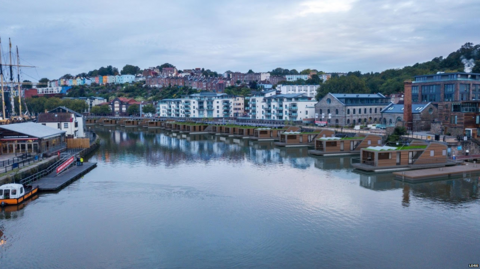 Looking down on Bristol harbour with an artists impression of what the floating homes would look like lined up on the waters edge opposite the SS Great Britain