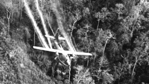 US air force jet flies over an area near Saigon spraying Agent Orange in 1968