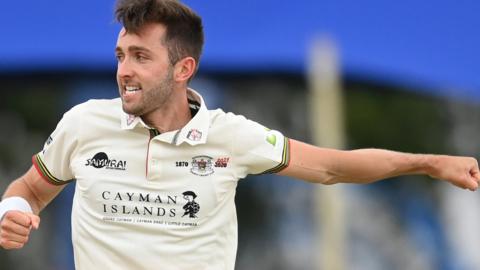 Gloucestershire bowler Matt Taylor celebrates taking a wicket against Middlesex