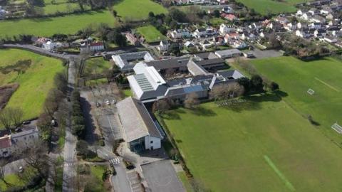 A secondary school site from above, surrounded by fields.