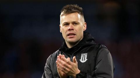 Interim Stoke boss Ryan Shawcross claps the travelling fans after his side's 0-0 draw with Burnley