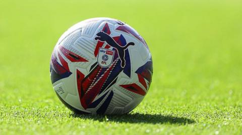 A football on a grass pitch