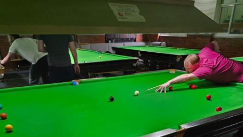 Players at a snooker event to raise money
