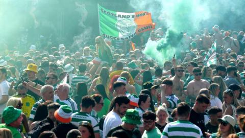 Celtic fans let off smoke bombs after gathering in the Trongate area after the match