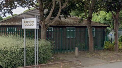 A street view image of the Beeches GOLDD building. The street is lined with trees 