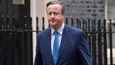 Lord David Cameron leaves 10 Downing Street during his time as foreign secretary